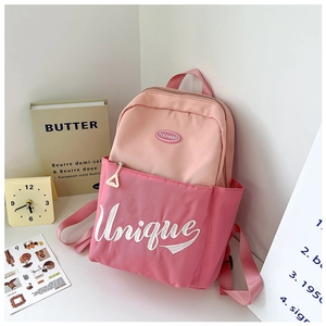 Detail view of pink color-block school backpack with Unique embroidery and letter decor