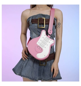 Close-up of pink and white guitar-shaped crossbody bag featuring mock strings and strap