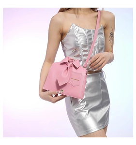 Detail of pink shirt-shaped PU leather crossbody bag with tie and golden hook
