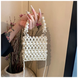 Close-up of handmade white pearl woven mini handbag featuring elegant beaded texture
