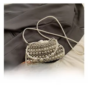 Detail of beaded mini crossbody bag with satin drawstring and white pearl chain strap