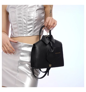 Unique shirt-shaped black leather tote bag with tie detail and gold fashion lettering