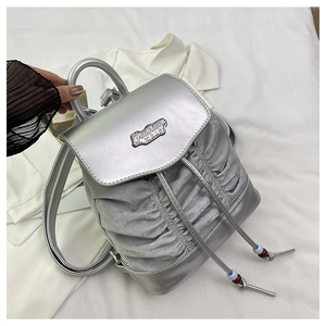 Detail of silver pleated rucksack with metal ring handle and Fashion BAG label