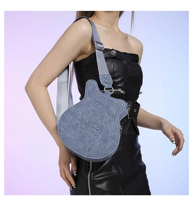 Detail of creative blue denim guitar shaped crossbody bag with metallic silver rivets