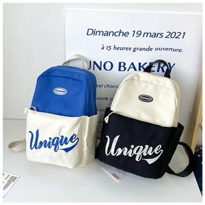 Detail of embroidered unique lettering and brand logo on canvas kids backpack