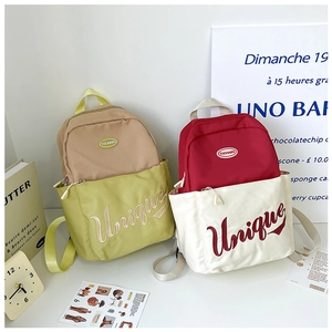 Detail of colorful nylon kid backpacks with Unique embroidery and contrasting panels