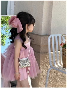 Detail of pink pearl crossbody bag paired with a layered mesh tulle princess dress