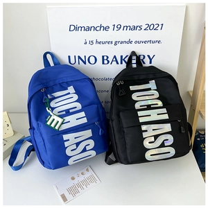 Front view of royal blue and black waterproof school bags with silver laser TOCHASO letters