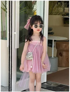 Detail view of pink layered mesh dress with pearl handbag and accessories for girls
