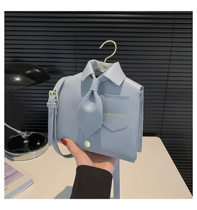 Close-up of creative shirt-shaped light blue PU leather shoulder bag with fashion printing
