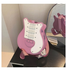 Detail of pink electric guitar shaped crossbody bag with stitching and rivet accents