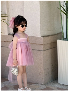 Detail of pink tutu dress with layered tulle and wide straps worn by child model