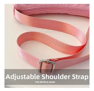 Close-up of adjustable pink fabric shoulder strap with polished silver metal buckle