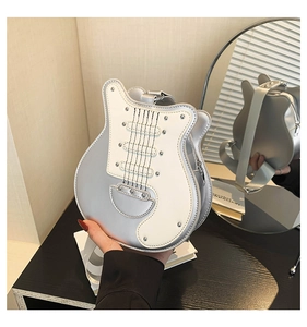 Detailed view of guitar-shaped crossbody bag featuring silver faux leather and metal studs