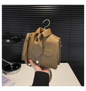 Detailed view of the creative shirt-style brown leather bag with a tie and collar design