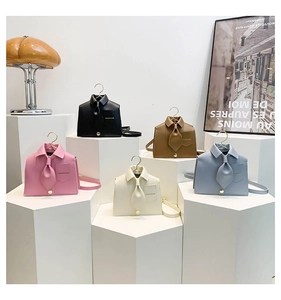 Detail of creative shirt-shaped crossbody bags in five colors with unique hanger handles