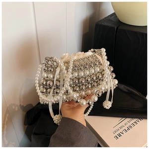 Detail of handcrafted mini pearl and silver beaded crossbody bag with drawstring liner