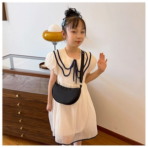 Detail of sailor collar children dress with navy wave trim and black crescent bag