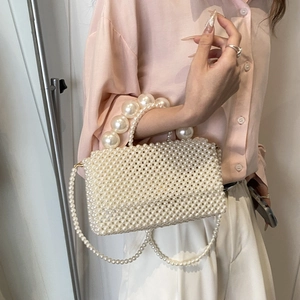 Elegant white pearl woven handbag with oversized pearl handle and long chain strap for women