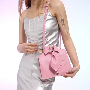 Chic pink shirt-shaped leather handbag with gold hanger handle and shoulder strap