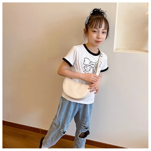 Kids off-white semi-circle crossbody bag shown on model for size and style reference