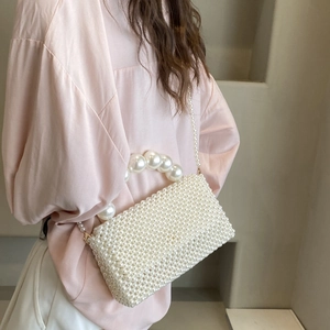 Elegant white pearl woven handbag with top handle and crossbody chain for women fashion