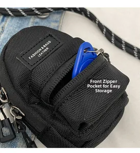 Close-up of functional zippered front pocket on mini nylon crossbody bag with leather label