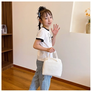Close-up of minimalist white canvas lunch bag with sturdy handles and clean stitching