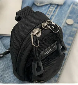 Detail of mini black leopard nylon crossbody bag with dual zipper design and leather tag