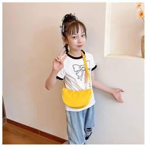Detail of kids bright yellow half-moon crossbody bag with adjustable nylon shoulder strap