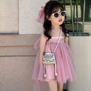 Pink girl's tulle dress with oversized bow headband and pearl mini crossbody bag