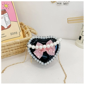 Close-up of heart-shaped kids crossbody bag with lace edges and pink mesh bow