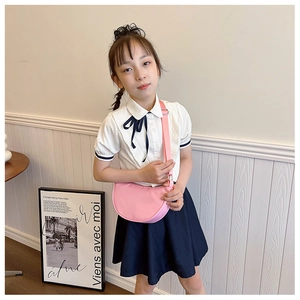 Detail of pink semi-circular crossbody bag for kids with adjustable nylon strap