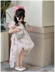 Close-up of pink rose floral summer dress for girls with puff sleeves and uneven hemline