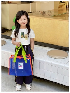 Détail du sac en maille pour enfants avec poignées contrastées et broderie florale