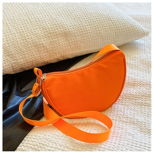 Detailed close-up of a bright orange semicircular kids crossbody bag with adjustable strap
