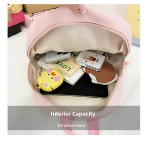 Internal capacity of kids pink backpack showing storage for books and electronic devices