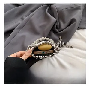 Internal view of silver beaded mini bucket bag showing phone and small accessories storage
