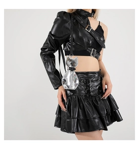 Detail of a silver glossy cat-shaped crossbody bag paired with a black punk style outfit