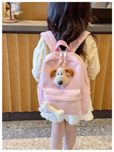 Pink schoolbag featuring plush Gromit dog character and a small bone charm accessory