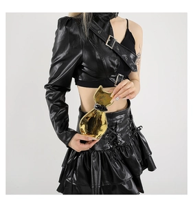 Detail of cute golden cat-shaped mini crossbody bag with mirror finish and buckle strap