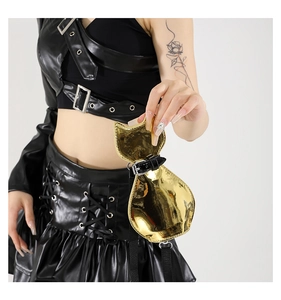 Macro detail of cat-shaped mini crossbody bag in mirror gold finish with black strap