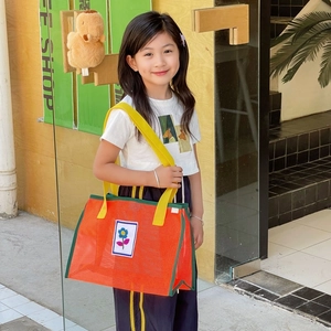 Sac fourre-tout en filet orange pour enfants avec poignées jaunes et fleur bleue