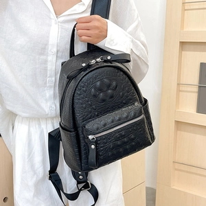Minimalist black crocodile pattern backpack featuring a cute 3D paw print design for women