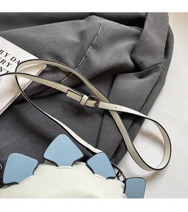 Detail of adjustable shoulder strap with metal buckle on the creative dinosaur bag