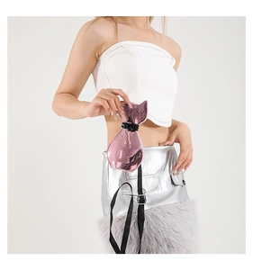 Close-up of pink metallic cat-shaped mini bag with black leather collar on model