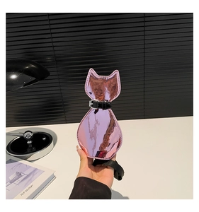 Detailed macro view of the glossy pink cat-shaped shoulder bag with black leather strap
