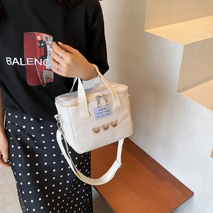 Large beige canvas diaper bag with cute bear embroidery and adjustable crossbody strap