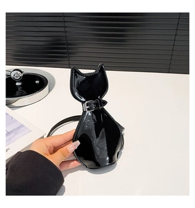 Detail of creative cat-shaped mini bag in glossy black patent leather with strap