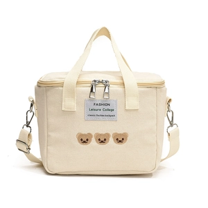 Cream canvas diaper bag with cute bear embroidery and adjustable shoulder strap